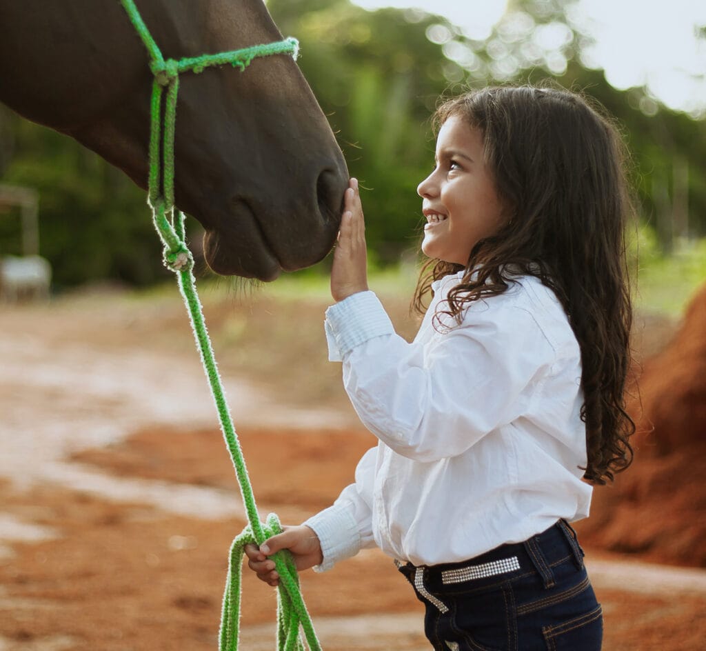 Photo of young girl has a moment with her horse
