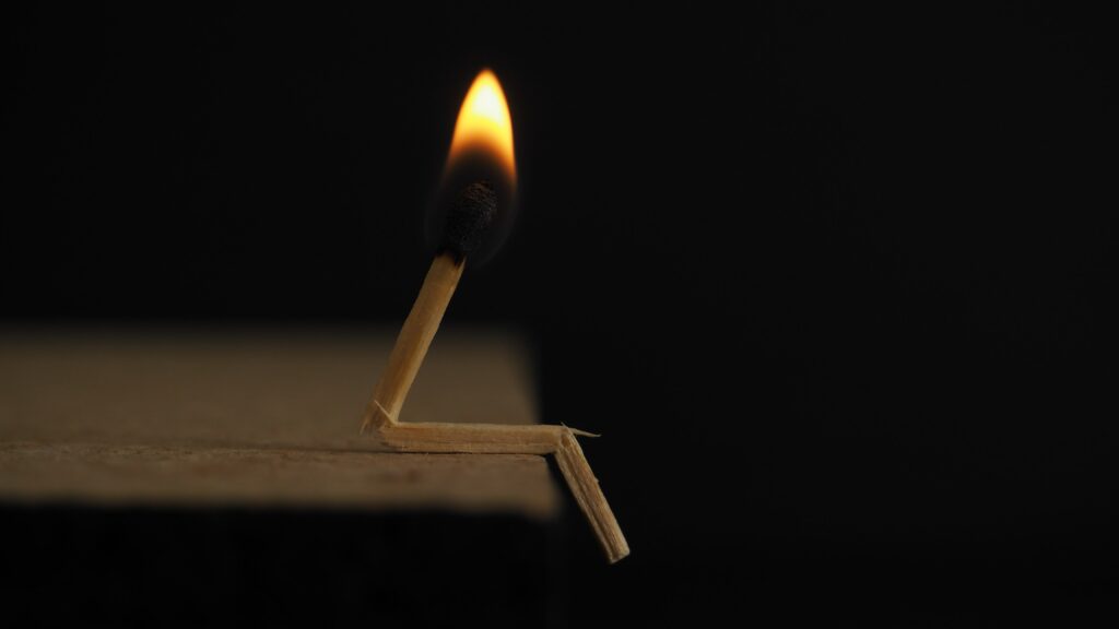 Image of lit matchstick representing staff burnout