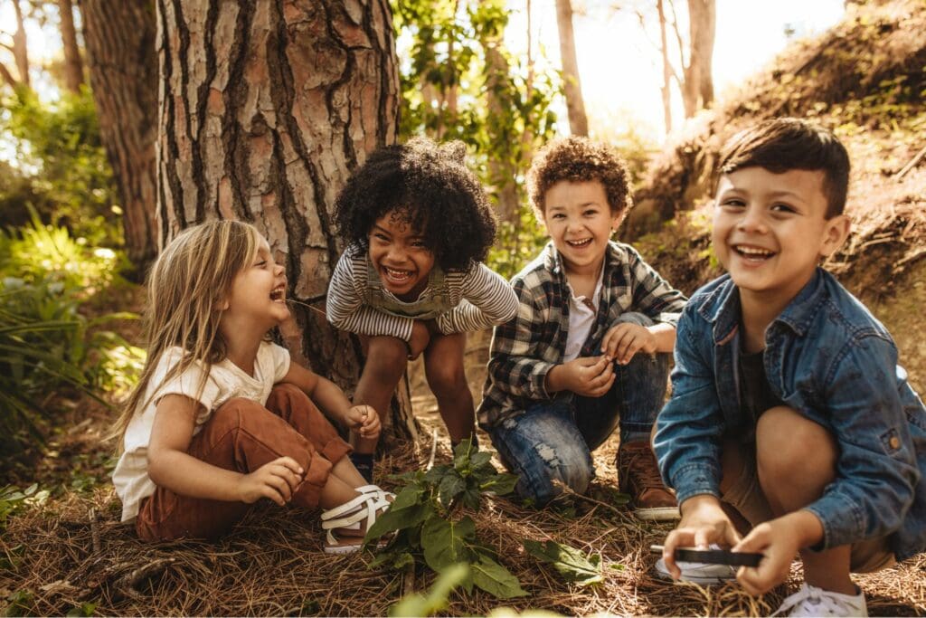 Kids laughing in the woods.